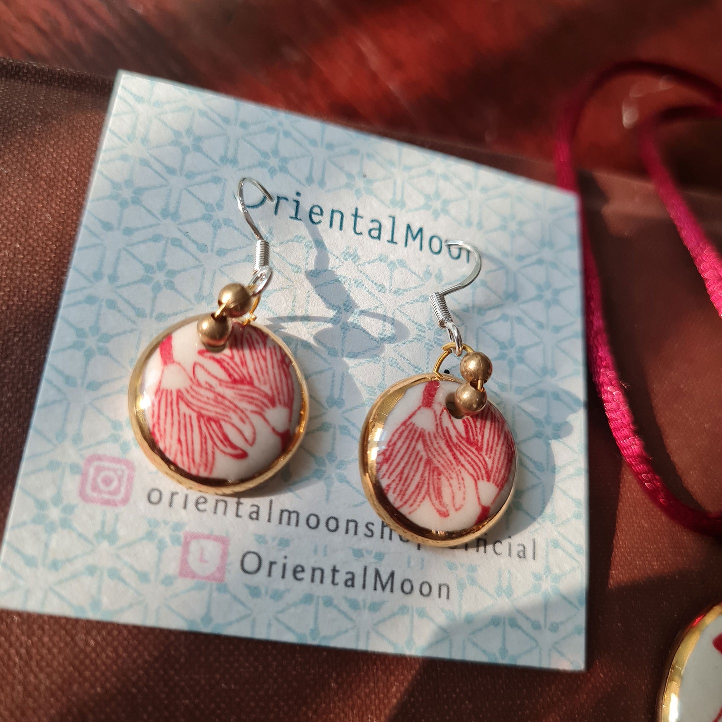 Set of Jumpa illustration pendant gold rim painted and hanging circle earrings