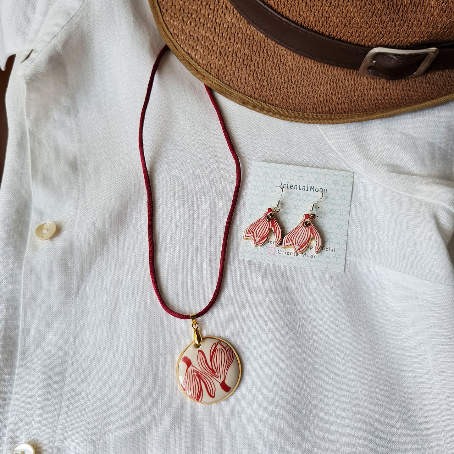 Set of Jumpa illustration pendant gold rim painted and hanging earrings